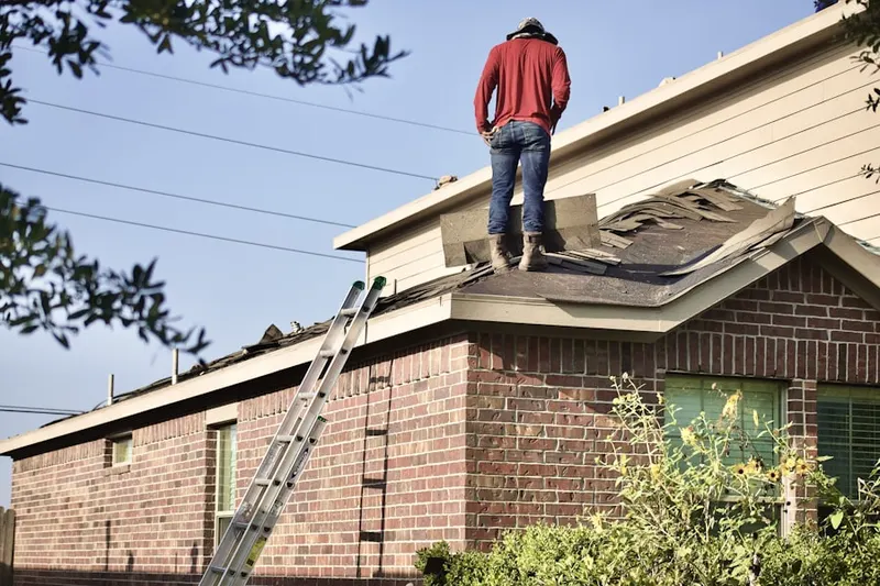 Professional roofer working on a residential roof in Park La Brea